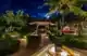 Serene night garden with a fountain and gazebo, perfect for dining in Maldives under moonlight.