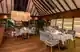 Maldives dining places with elegant wood and white furniture, offering a warm, inviting ambiance.