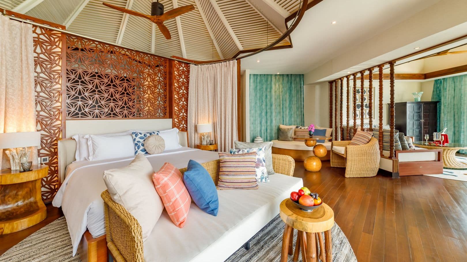 Luxury villas in Maldives with Ocean Pool Suite, tranquil pool and thatched huts under blue sky.