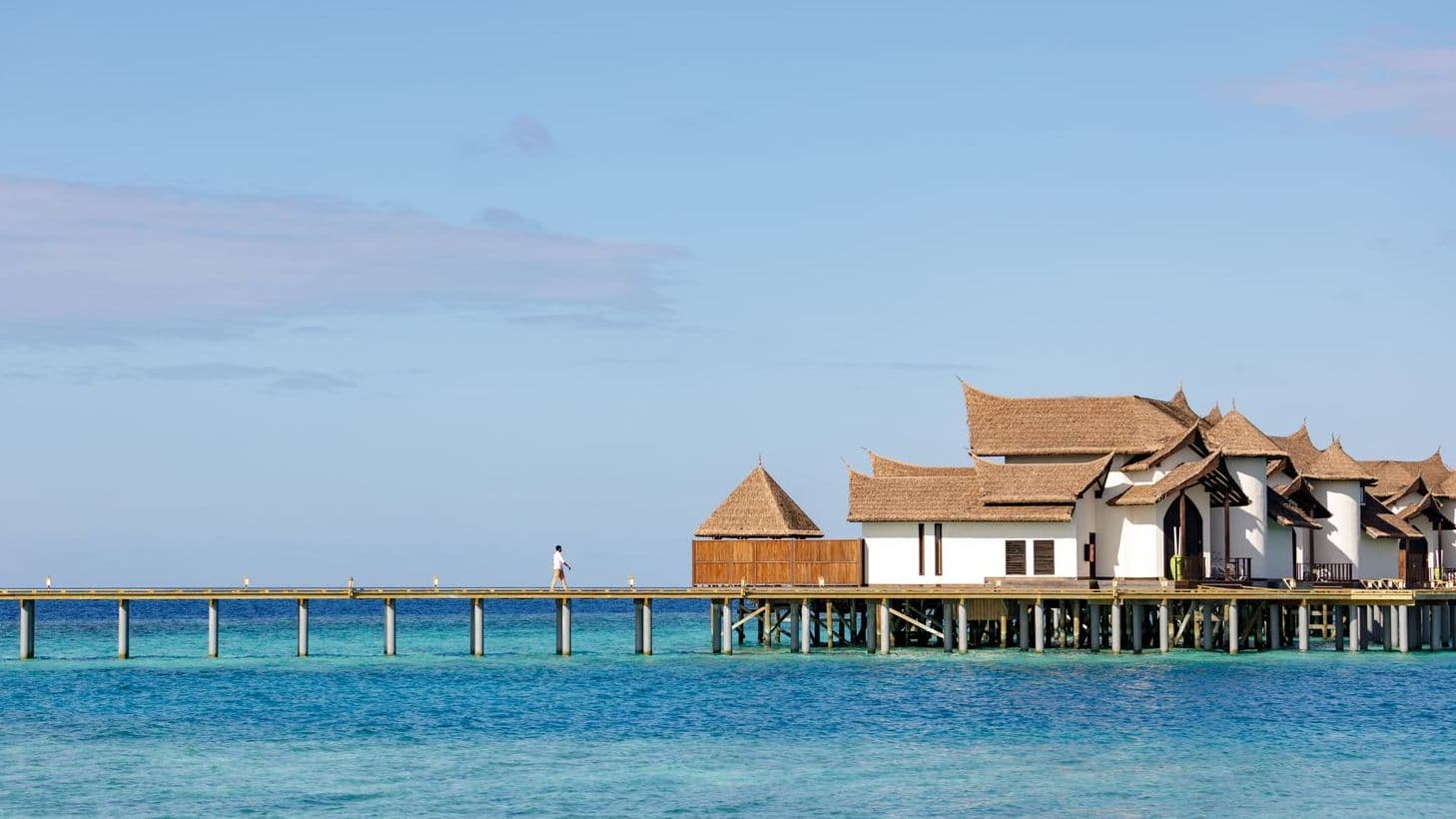 Overwater bungalows on tranquil waters at a Maldives resort on water, offering serene escape.