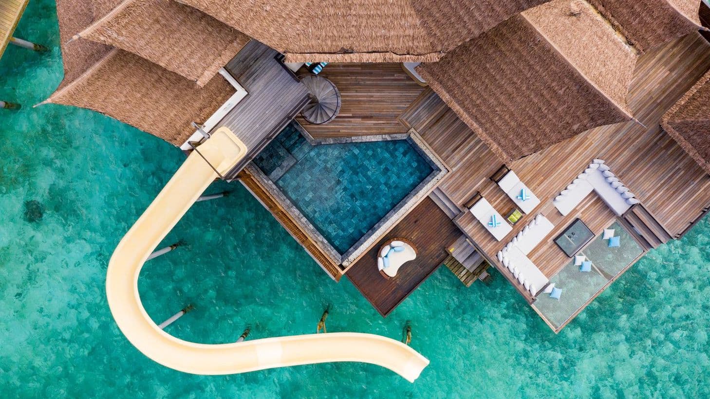 Overwater bungalows on tranquil waters at a Maldives resort on water, offering serene escape.