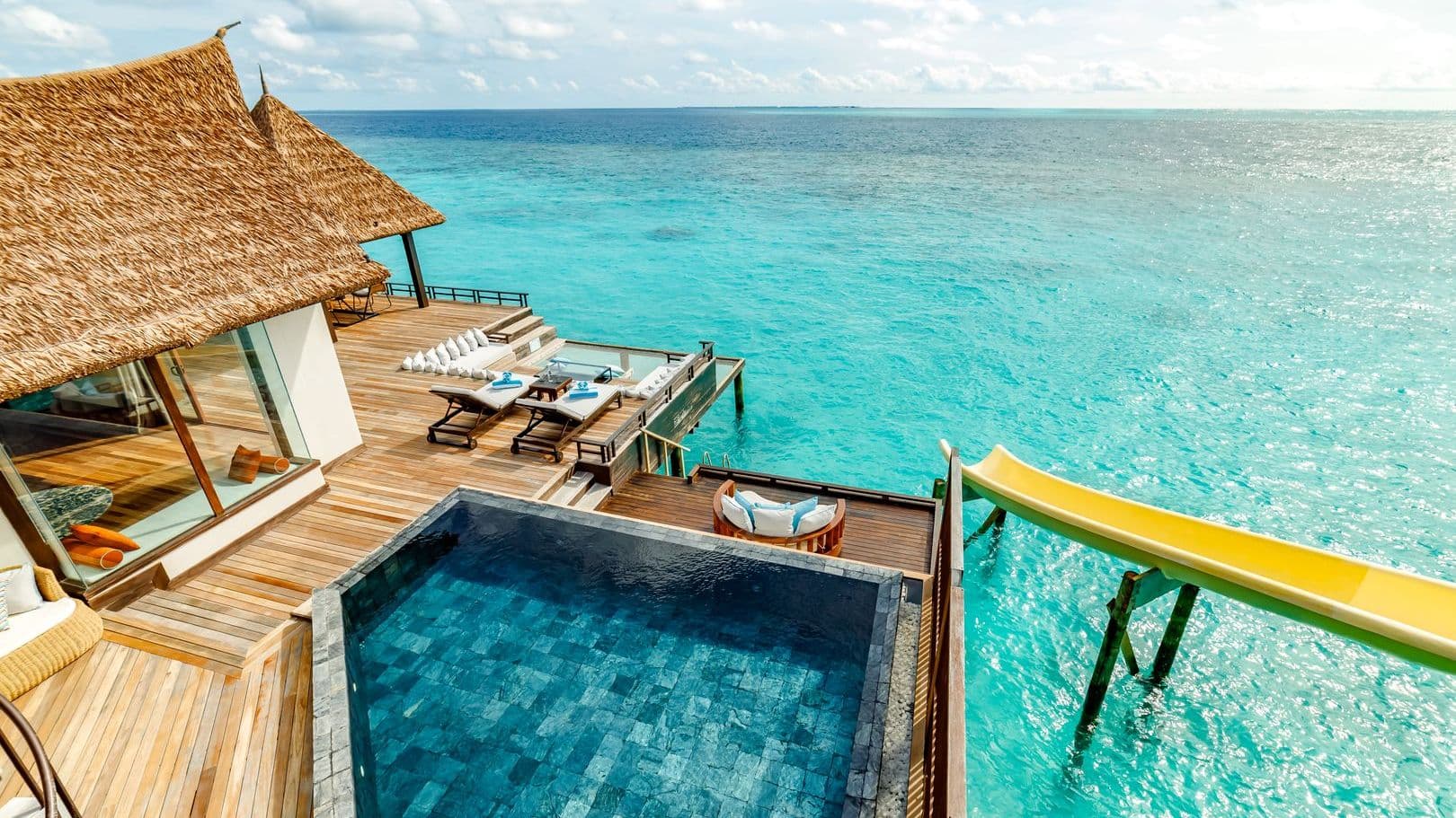 Overwater bungalows on tranquil waters at a Maldives resort on water, offering serene escape.
