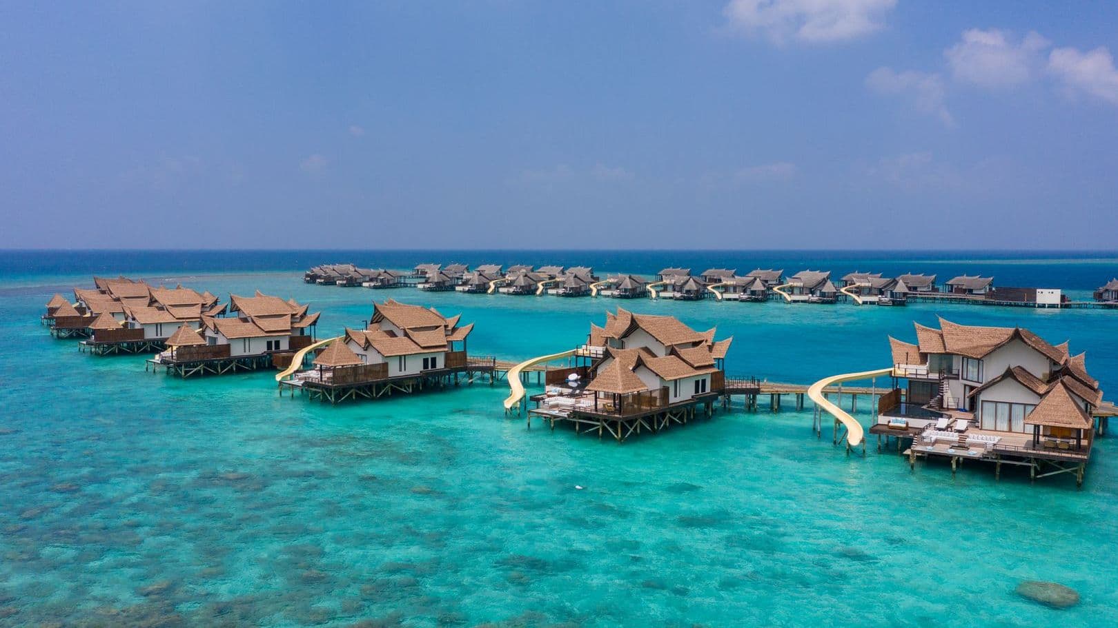 Overwater bungalows on tranquil waters at a Maldives resort on water, offering serene escape.