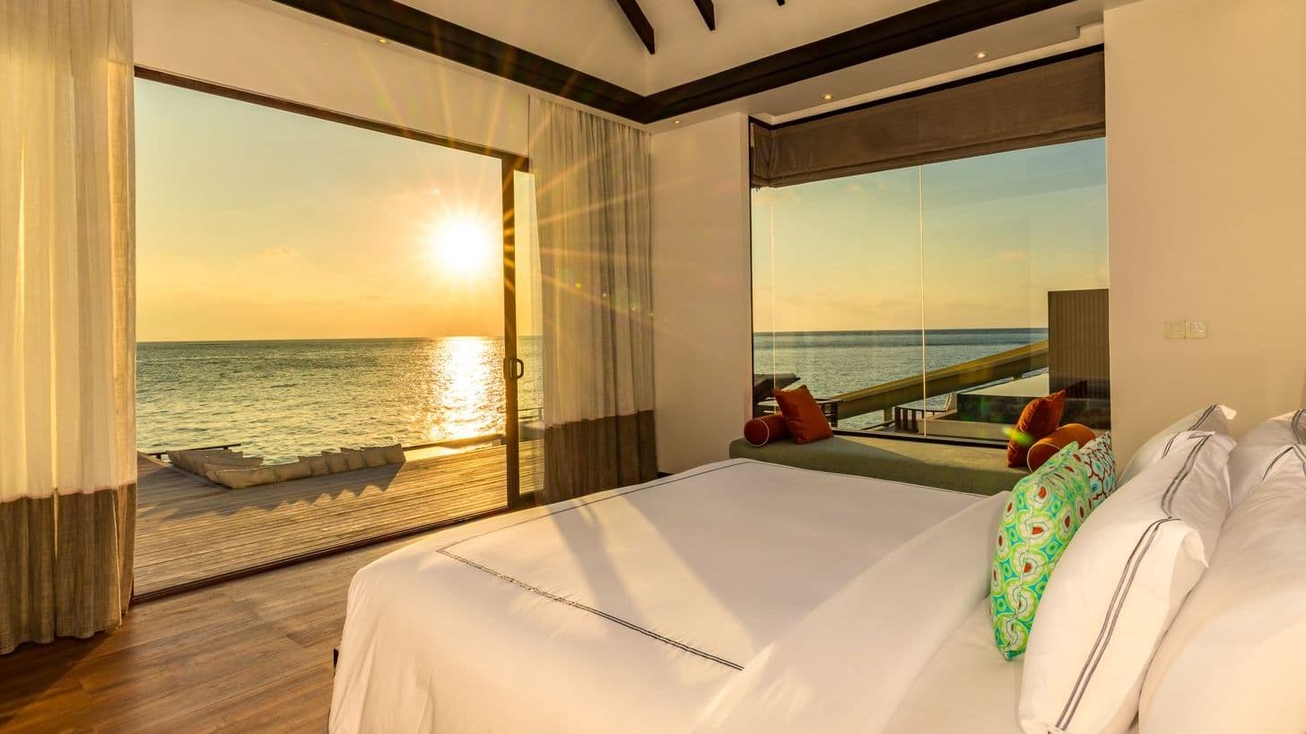 Overwater bungalows on tranquil waters at a Maldives resort on water, offering serene escape.